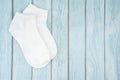 A White cotton socks for design on blue wooden background