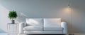 A white couch is in front of a wall with a plant and a lamp. Royalty Free Stock Photo