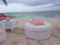 White couch and red pillow in the beach