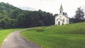 White Country Church on a Grassy Hillside