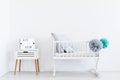 White cradle with pastel pompons Royalty Free Stock Photo