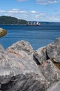 White Crane Boat with Rocks in Foreground Baie-Comeau Quebec Royalty Free Stock Photo