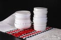 White creal and soup bowls stacked on a black table Royalty Free Stock Photo