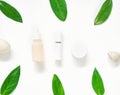 White cream bottle placed, Blank label package for mock up on a green foliage background and flowers. The concept of natural beaut Royalty Free Stock Photo