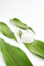 White cream bottle placed, Blank label package for mock up on a green foliage background. Royalty Free Stock Photo