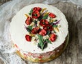 White cream cake decorated with buttercream flowers, Poppies, chamomile, cornflowers, spikelets of wheat, on gray background. Royalty Free Stock Photo