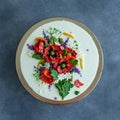 White cream cake decorated with buttercream flowers, Poppies, chamomile, cornflowers, spikelets of wheat, on gray background. Royalty Free Stock Photo