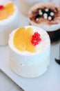 White cream cakes with fruits and berries in a restaraunt.