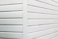 White or cream coloured wooden panelling corner of shed or hut