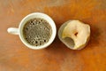 White cream donuts bite and black coffee cup on wooden board background Royalty Free Stock Photo