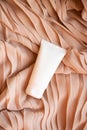 White cream tube mock-up on textile background Royalty Free Stock Photo