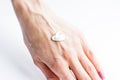 White cream on a woman's hand on a white background .Woman at home spa creaming hands close up photo