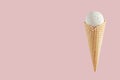 White creamy ice cream in crisp waffle cone on soft light pastel pink background, mock up, copy space. Royalty Free Stock Photo