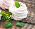 White creamy marshmallow handmade. Adorned with mint leaves. On a wooden background. Close-up Royalty Free Stock Photo