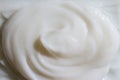 White creamy mud texture, curls. Cellulite dirt. Lotion, moisturizer, skin care product smear.