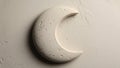 White crescent moon sculpture against a textured plaster like beige wall Royalty Free Stock Photo