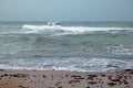 WHITE CRESTED WAVES ROLLING TO THE SHORE Royalty Free Stock Photo