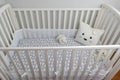 White crib and light gray walls for baby`s room Royalty Free Stock Photo