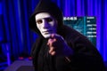 White criminal anonymous mask pointing to camera as hack programmer. Surmise.