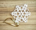 White crochet christmas decoration on the wooden texture