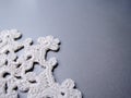 White crocheted doily on a gray background close-up