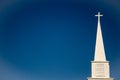 White Cross Atop a Church Steeple Royalty Free Stock Photo