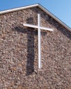 White cross on stone church building