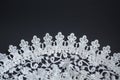 White crotcheted lace pattern on dark background as wallpaper Royalty Free Stock Photo