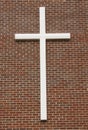 White crucifix on brick wall