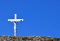 White cross with Jesus with blue sky