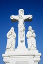 White crucifix sculpture and blue sky background