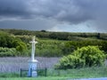 white cross in hill landscape