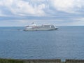 A white cruise ship sailing off the English coast near Falmouth