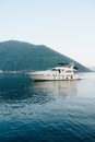 White cruise yacht on the water near the mountains in Montenegro.