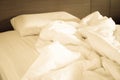 White crumpled bed sheet and messy pillows in a hotel room Royalty Free Stock Photo