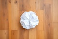 white crumpled paper ball on wood surface Royalty Free Stock Photo