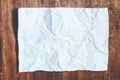 White crumpled paper on wood background Royalty Free Stock Photo