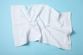 White crumpled towels on blue background