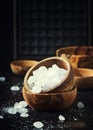 White crystal candy sugar in wooden bowl on black table, selective focus Royalty Free Stock Photo