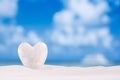 White crystal heart on white sand beach Royalty Free Stock Photo