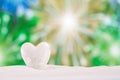 White crystal heart on white sand beach Royalty Free Stock Photo