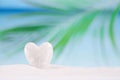 White crystal heart on white sand beach Royalty Free Stock Photo