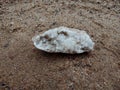 white crystal stone with texture on the sand. textured background wallpaper, beach. ocean. Royalty Free Stock Photo