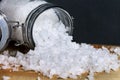 White crystals sea salt in glass bottles on orange ston