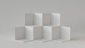 White cube boxes with white blank wall background. 3D rendering. Royalty Free Stock Photo