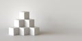 White cube boxes with white blank wall background. 3D rendering. Royalty Free Stock Photo