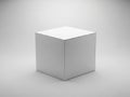 A white cube is centered on a gray background with subtle shading Royalty Free Stock Photo