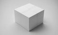 A white cube with lines on each face sits on a light gray surface Royalty Free Stock Photo
