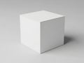 A white cube on a plain gray background with subtle shadow effect Royalty Free Stock Photo