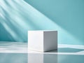 White cube on a reflective surface with teal background and shadow patterns for product display Royalty Free Stock Photo